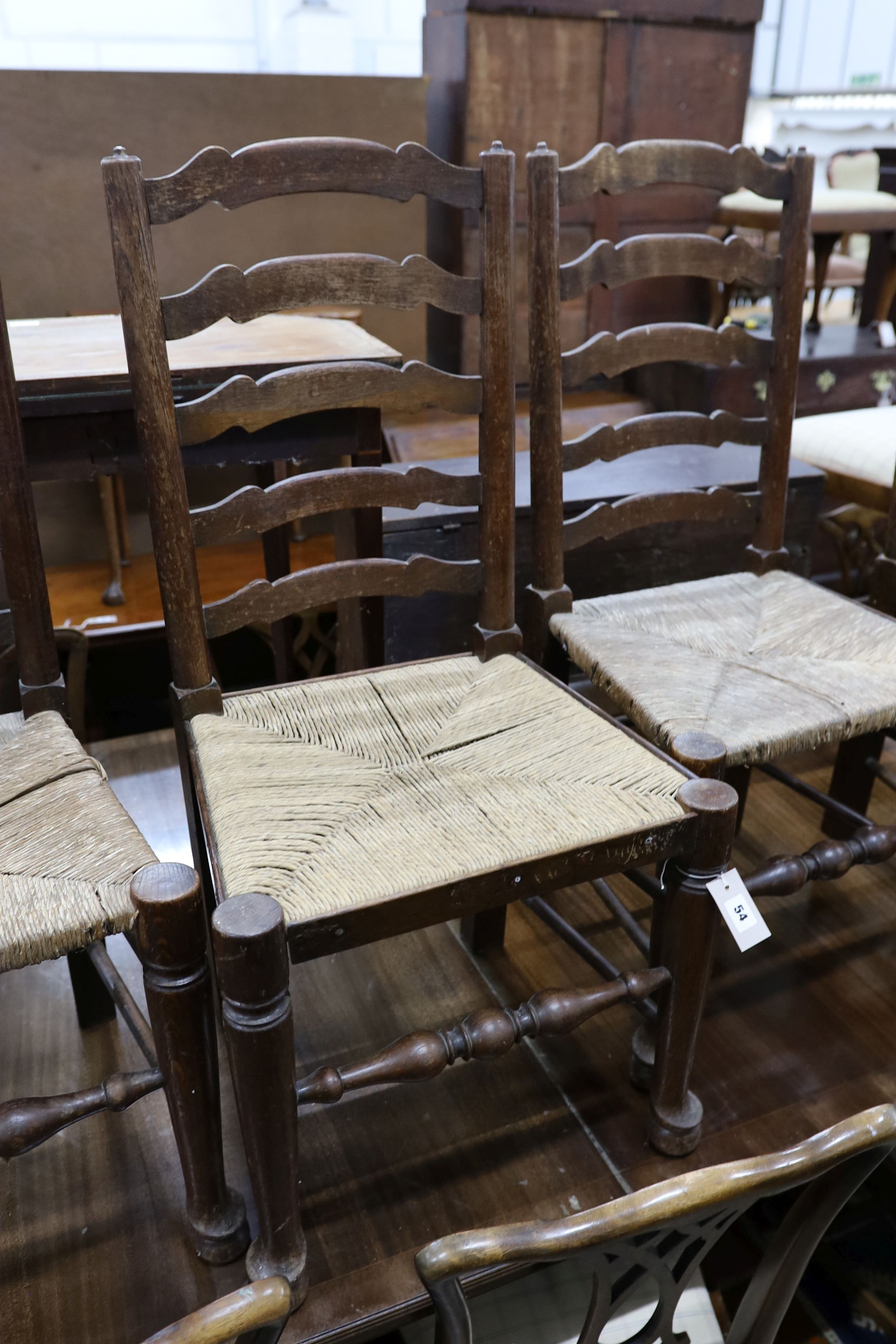 A set of six oak rush seat ladder back chairs